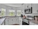 Well-appointed kitchen with white cabinets and stainless steel appliances at 4582 Penkert Pl, Lakeland, FL 33811