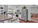 Bright kitchen with white cabinetry, stainless steel appliances, and wood-look flooring at 4582 Penkert Pl, Lakeland, FL 33811