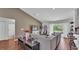 Open concept living room, featuring hardwood floors, neutral walls, and access to the kitchen at 4582 Penkert Pl, Lakeland, FL 33811