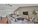 Spacious living room, featuring hardwood floors, neutral walls, with access to kitchen and dining area at 4582 Penkert Pl, Lakeland, FL 33811