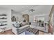 Open-concept living room with hardwood floors, a ceiling fan and neutral walls at 4582 Penkert Pl, Lakeland, FL 33811