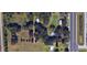 Aerial view of property showcasing proximity to road with mature landscaping and a pool at 5211 Berkley Rd, Auburndale, FL 33823