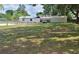 Spacious backyard, featuring utility building, full chain-link fence, and parking area at 5211 Berkley Rd, Auburndale, FL 33823