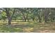 Large backyard with mature trees, full fence, and well-maintained lawn at 5211 Berkley Rd, Auburndale, FL 33823