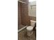 Bathroom with a tile shower, a modern toilet, and warm earth-toned accents at 5211 Berkley Rd, Auburndale, FL 33823