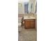 Cozy bathroom featuring tile floors, a classic vanity, and a mirrored wall cabinet with a view into the bedroom at 5211 Berkley Rd, Auburndale, FL 33823