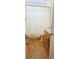 Compact bathroom featuring a shower with palm tree curtain, wood vanity and laminate flooring at 5211 Berkley Rd, Auburndale, FL 33823