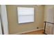 Bright bedroom with warm wood flooring and a window covered with a white blind at 5211 Berkley Rd, Auburndale, FL 33823