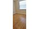 Bright bedroom with laminate wood flooring and a window covered with a white blind at 5211 Berkley Rd, Auburndale, FL 33823