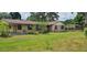 Single story home with a large front yard and attached carport, offering a cozy suburban feel at 5211 Berkley Rd, Auburndale, FL 33823