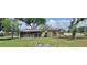 Charming single-story home featuring mature trees and a spacious yard at 5211 Berkley Rd, Auburndale, FL 33823