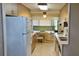 Functional kitchen with wooden cabinets, essential appliances, and a breakfast nook for casual meals at 5211 Berkley Rd, Auburndale, FL 33823