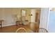 Cozy living room showcases hardwood floors with a comfortable armchair and dining area in the background at 5211 Berkley Rd, Auburndale, FL 33823