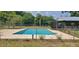 An in-ground pool is surrounded by concrete at 5211 Berkley Rd, Auburndale, FL 33823