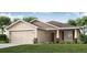 Charming single-story home features a two-car garage, well-manicured lawn, and inviting entryway at 5432 Se 127Th Ln, Belleview, FL 34420