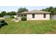 Back exterior featuring a home with a patio, Florida room, and green lawn with a lawnmower at 5733 Oakwood Knoll Dr, Lakeland, FL 33811