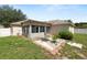 A spacious backyard with grass, a shed, patio, and access to the home at 5733 Oakwood Knoll Dr, Lakeland, FL 33811