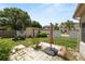 A backyard featuring a shed, lawnmower, patio, and lush greenery on a sunny day at 5733 Oakwood Knoll Dr, Lakeland, FL 33811