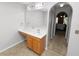 Bathroom with wood vanity, large mirror and neutral flooring at 5733 Oakwood Knoll Dr, Lakeland, FL 33811