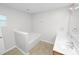 Bright bathroom features a garden tub, a single sink vanity and neutral flooring at 5733 Oakwood Knoll Dr, Lakeland, FL 33811