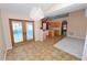 Open dining area with sliding glass doors, tile flooring, and chandelier, adjacent to the kitchen at 5733 Oakwood Knoll Dr, Lakeland, FL 33811