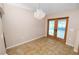 Bright dining room featuring tile floors, a chandelier, and a glass door that leads to the outside at 5733 Oakwood Knoll Dr, Lakeland, FL 33811