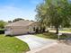 Charming single-story home with a well-manicured lawn, a two-car garage, and mature landscaping at 5733 Oakwood Knoll Dr, Lakeland, FL 33811