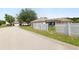 Exterior view of a single-Gathering home with a well-maintained lawn and a fenced backyard at 5733 Oakwood Knoll Dr, Lakeland, FL 33811