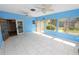 Bright Florida room with tile floor, ceiling fans, and access to the backyard at 5733 Oakwood Knoll Dr, Lakeland, FL 33811
