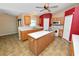 Open kitchen with wood cabinets, a center island, tiled flooring, and modern appliances at 5733 Oakwood Knoll Dr, Lakeland, FL 33811