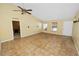 Open-plan living area with neutral paint, tile flooring, and natural light at 5733 Oakwood Knoll Dr, Lakeland, FL 33811