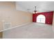 Spacious living room featuring neutral carpet, a ceiling fan, and a large window at 5733 Oakwood Knoll Dr, Lakeland, FL 33811