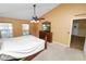 Primary bedroom featuring a ceiling fan, carpet floors, and natural light at 5733 Oakwood Knoll Dr, Lakeland, FL 33811