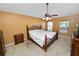 Primary bedroom featuring a ceiling fan, carpet floors, and natural light at 5733 Oakwood Knoll Dr, Lakeland, FL 33811