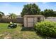 A well maintained shed with a green John Deere lawn mower to the left at 5733 Oakwood Knoll Dr, Lakeland, FL 33811