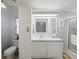 Light-filled bathroom featuring a vanity sink, shower and extra storage at 6087 Southern Oaks Se Dr, Winter Haven, FL 33884