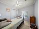 Cozy bedroom featuring neutral paint, ceiling fan, and natural light from the window at 6087 Southern Oaks Se Dr, Winter Haven, FL 33884