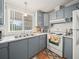 Beautiful kitchen with gray cabinets, marble countertops, and white appliances at 6087 Southern Oaks Se Dr, Winter Haven, FL 33884