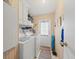 Efficient laundry room with a washer, dryer, and access to the exterior at 6087 Southern Oaks Se Dr, Winter Haven, FL 33884