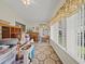 Bright living room with large windows, patterned rug, and ceiling fan shows potential at 6087 Southern Oaks Se Dr, Winter Haven, FL 33884