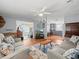 Spacious living room featuring hardwood floors, ceiling fan, and neutral paint at 6087 Southern Oaks Se Dr, Winter Haven, FL 33884