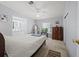 Bright main bedroom with an ensuite bath, comfortable bed, and a chest of drawers at 6087 Southern Oaks Se Dr, Winter Haven, FL 33884