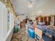 Enclosed sun room filled with boxes, a window, and door to the exterior at 6087 Southern Oaks Se Dr, Winter Haven, FL 33884