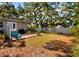 Secluded backyard featuring a brick patio with Adirondack chairs and mature trees for ample shade at 618 W Oak Dr, Lakeland, FL 33803