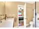 Bright bathroom vanity with modern tile backsplash next to bedroom access at 618 W Oak Dr, Lakeland, FL 33803