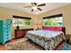 Serene bedroom with hardwood floors, two windows, and accent furniture at 618 W Oak Dr, Lakeland, FL 33803