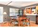 Dining room with hardwood floors, modern lighting, and adjacent kitchen and living spaces at 618 W Oak Dr, Lakeland, FL 33803