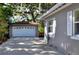 Driveway with a detached two car garage and side view of the house at 618 W Oak Dr, Lakeland, FL 33803