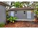 Exterior side view of house with two white doors, windows and foliage at 618 W Oak Dr, Lakeland, FL 33803