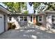 Home exterior showcasing a front entrance and concrete driveway surrounded by trees and landscaping at 618 W Oak Dr, Lakeland, FL 33803